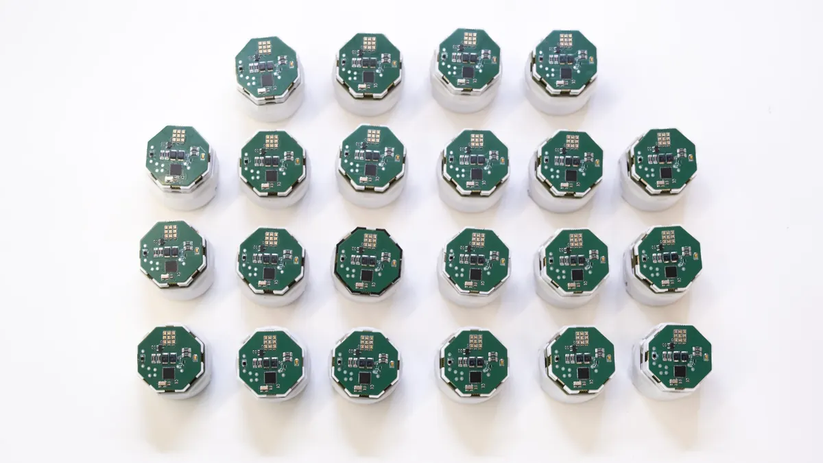 Twenty robots lined up in a tight grid.